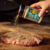 Angus & Oink Lemon Pepper wordt over vlees gestrooid